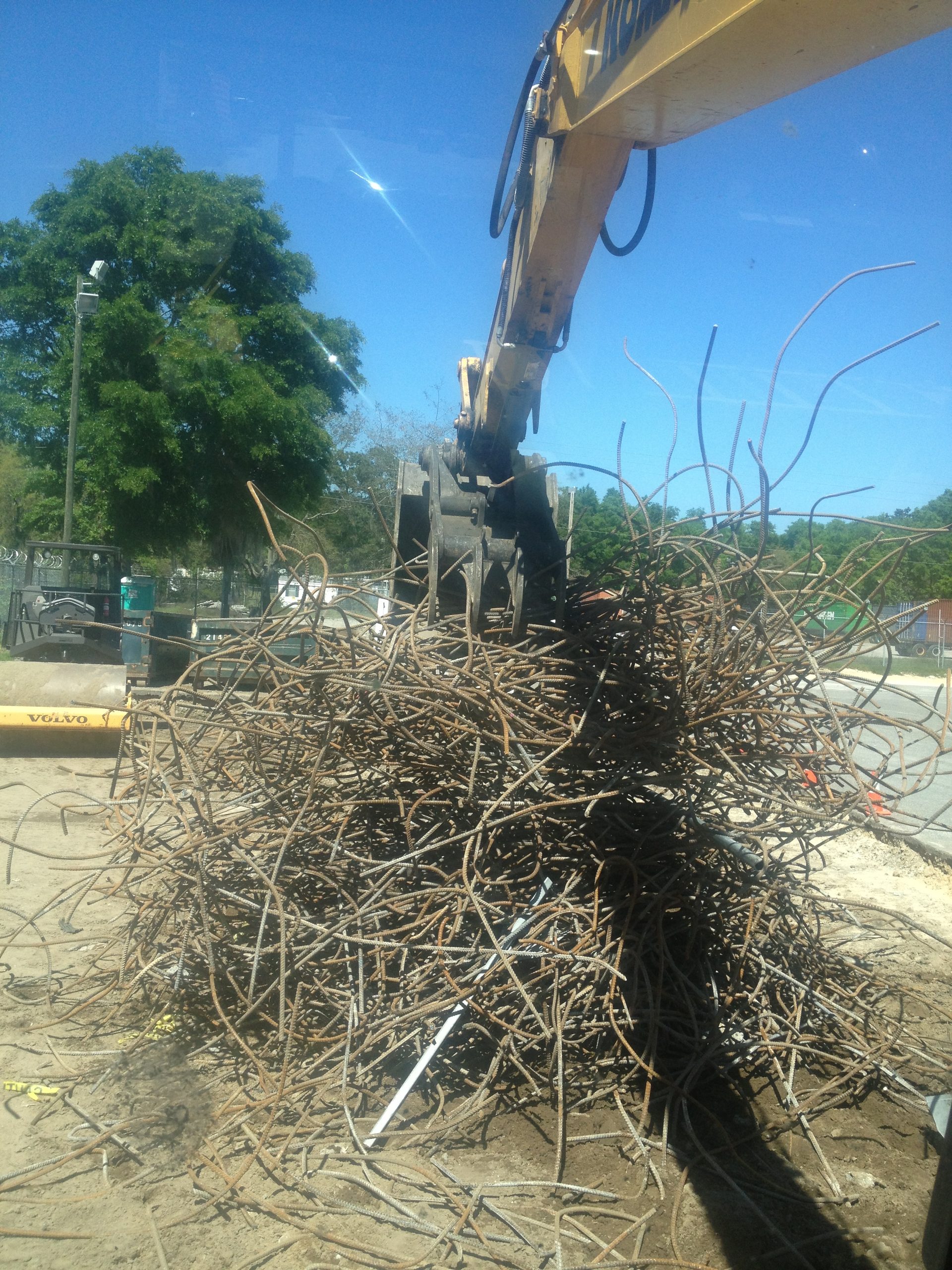Excavator loading brush and debris for hauling off a Middle Tennessee site