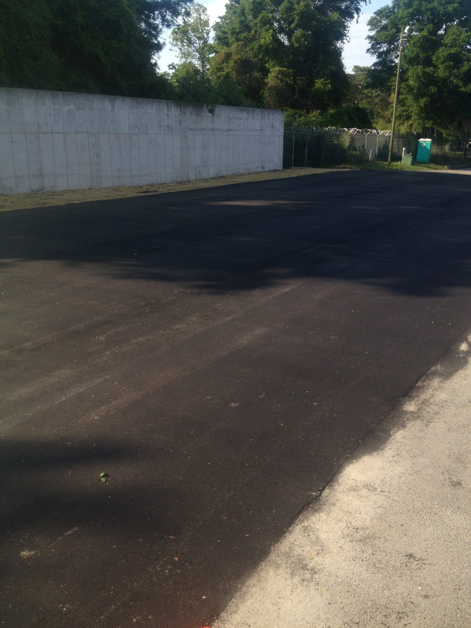 Newly paved asphalt driveway and parking area
