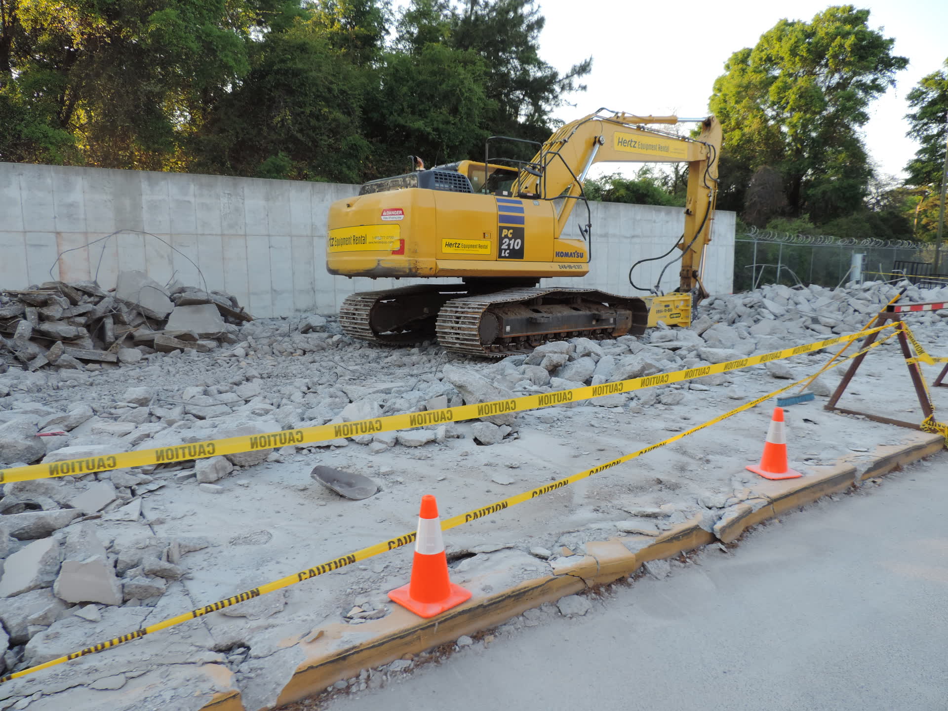 Tracked excavator breaking out a concrete slab